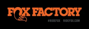 Orange Fox Factory logo with fox tail graphic on black background